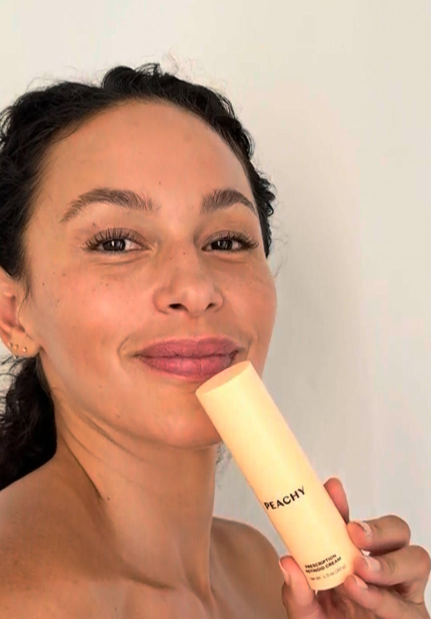 Smiling woman holding retinoid cream