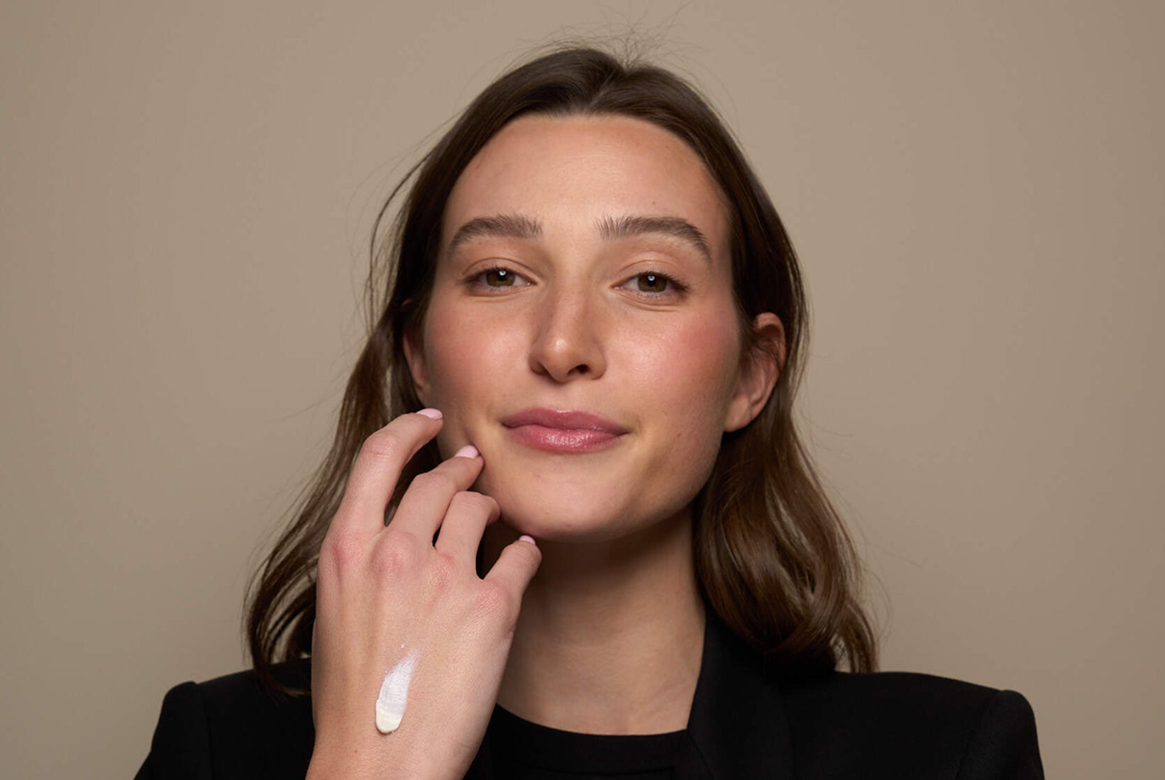 woman with lotion on back of hand