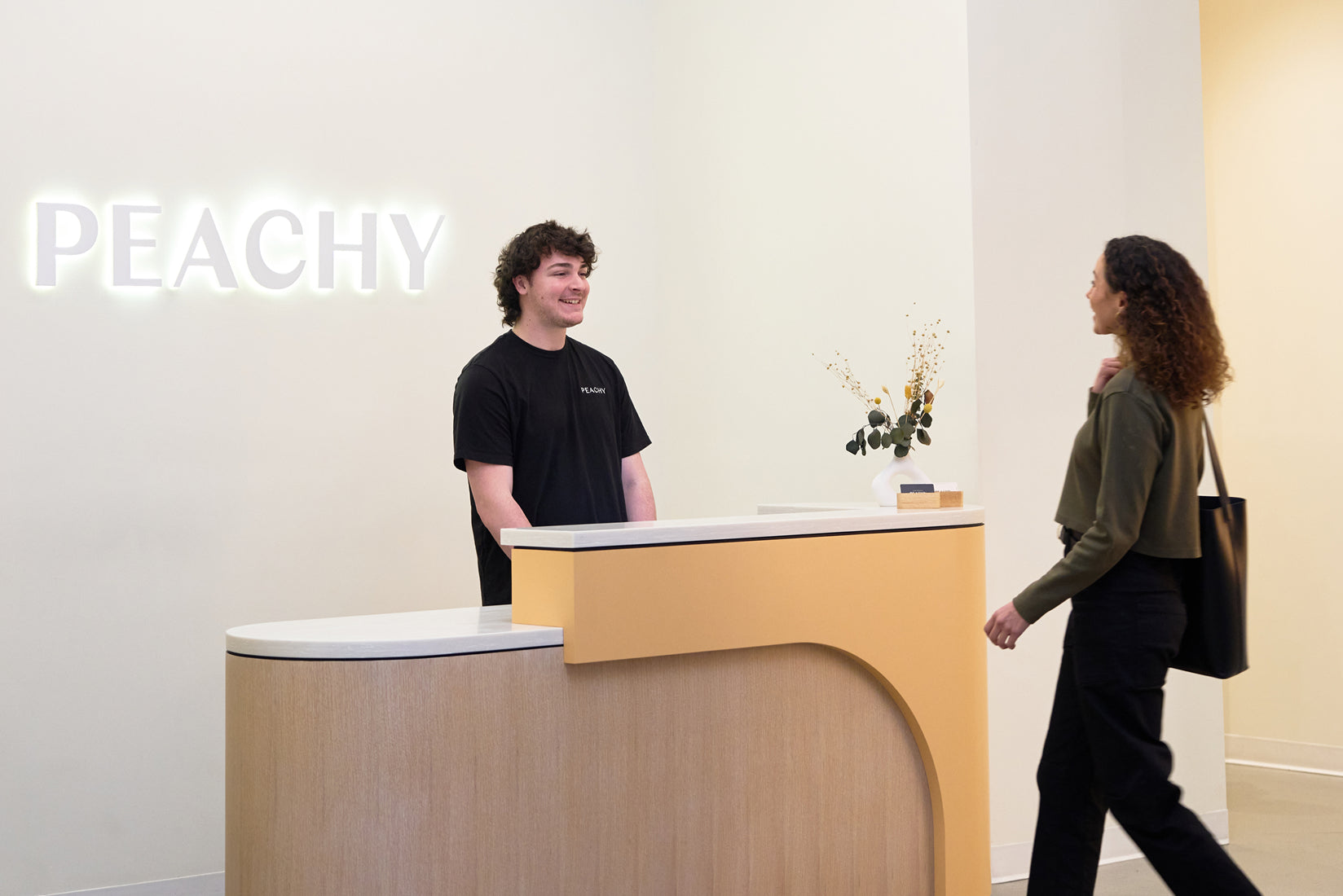 Client walking up to Peachy front desk