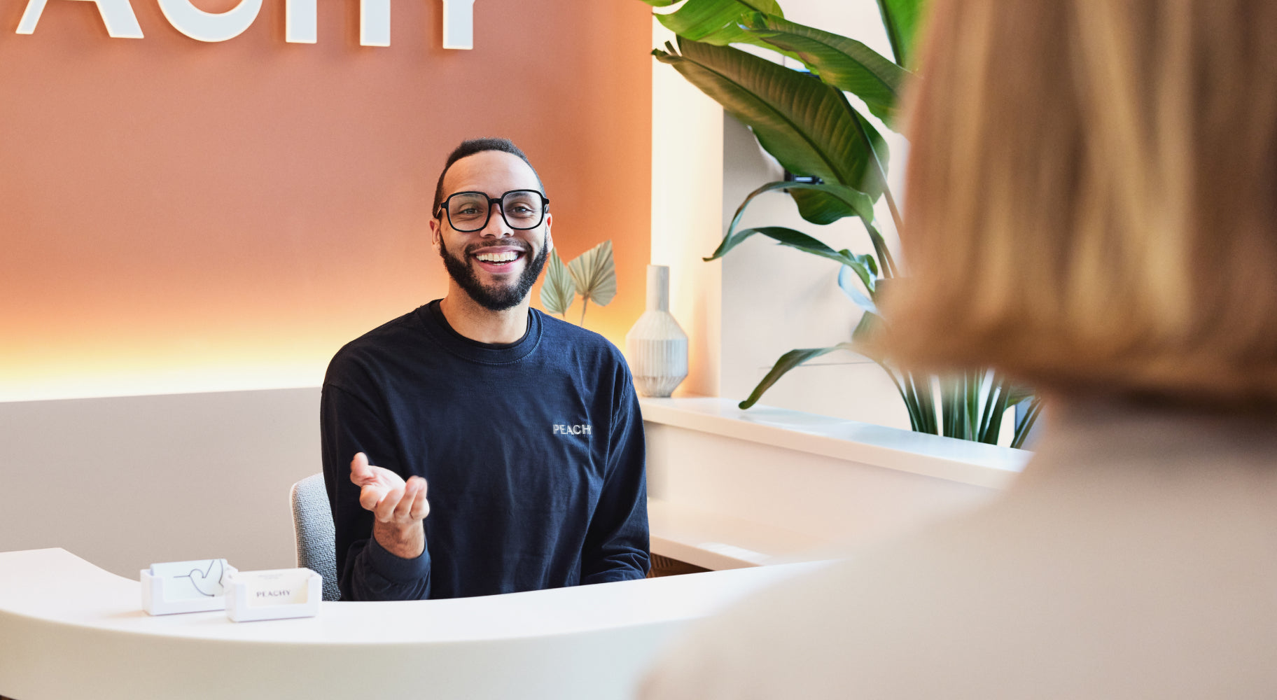 Person at front desk welcoming client