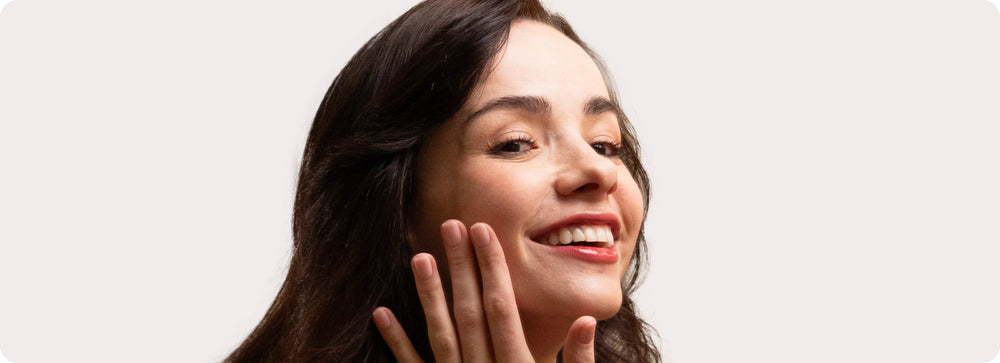 Woman touching her jawline with fingers