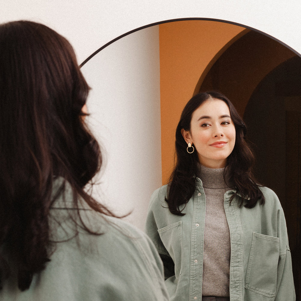 woman looking at self in mirror