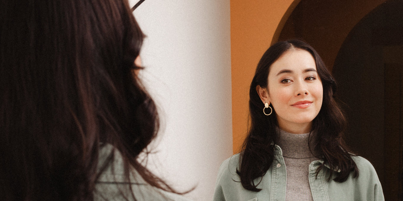 woman looking at self in mirror