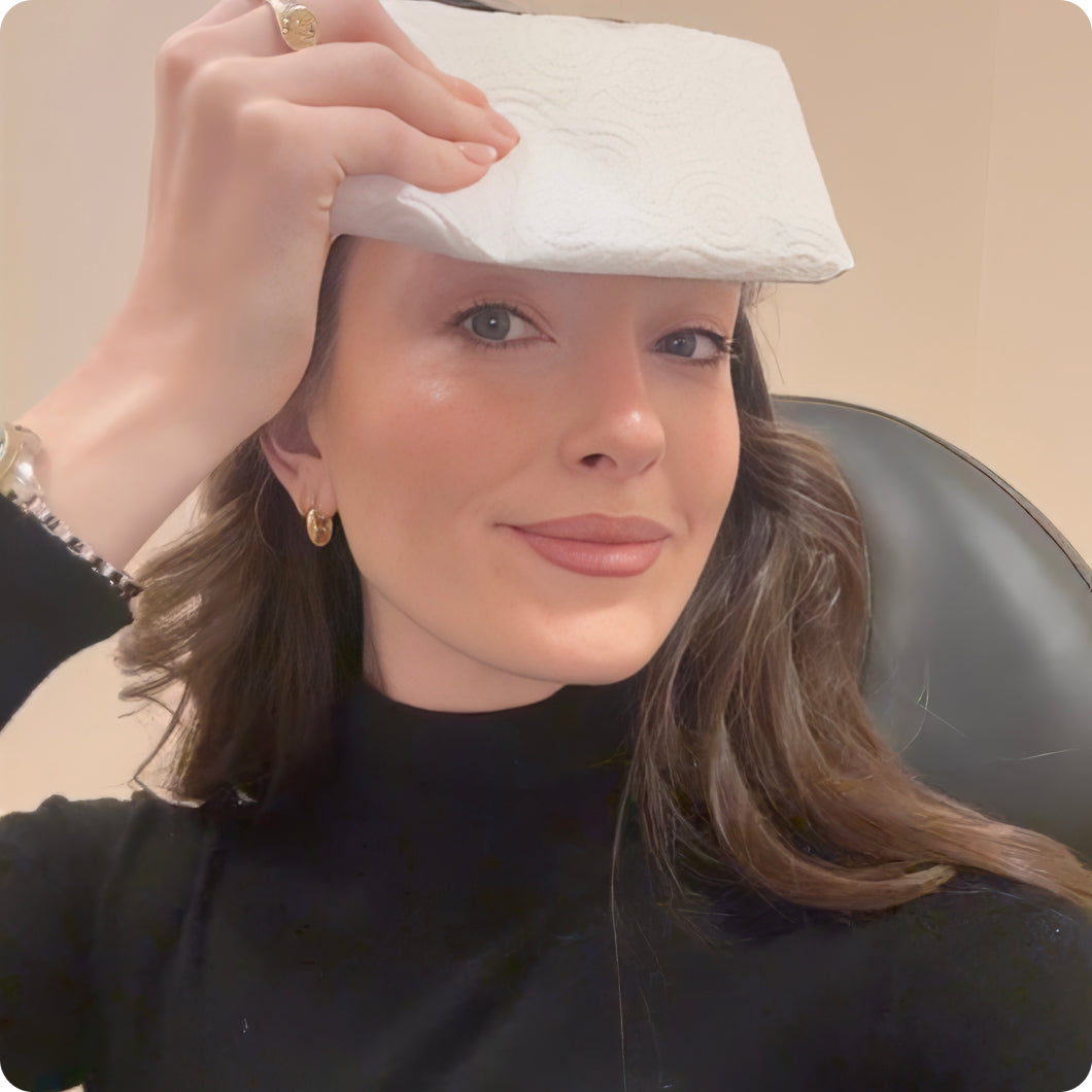 woman applying towel to forehead