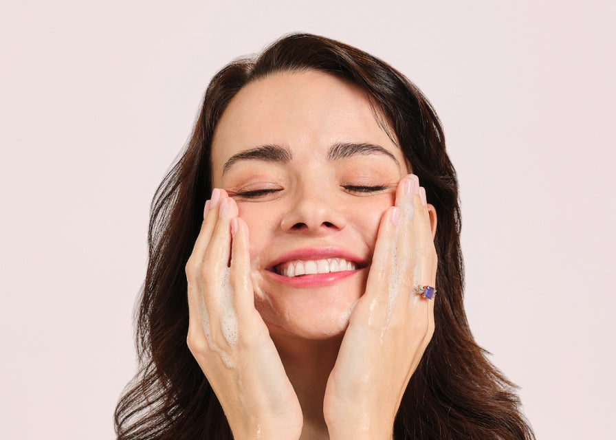 person applying Restorative Moisturizer to face