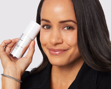 person holding retinoids container