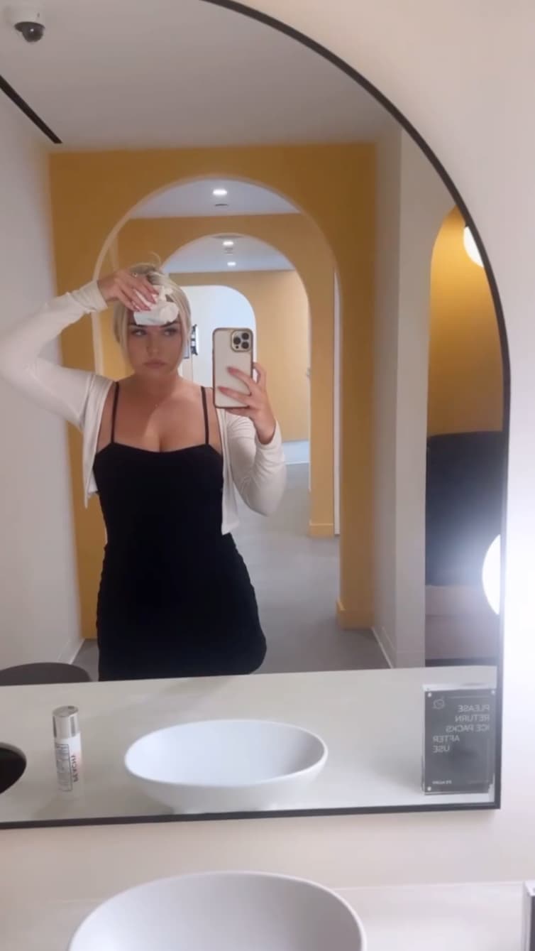 woman taking selfie in mirror