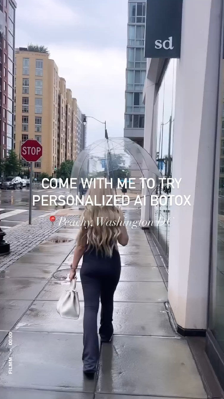 woman walking on sidewalk with umbrella