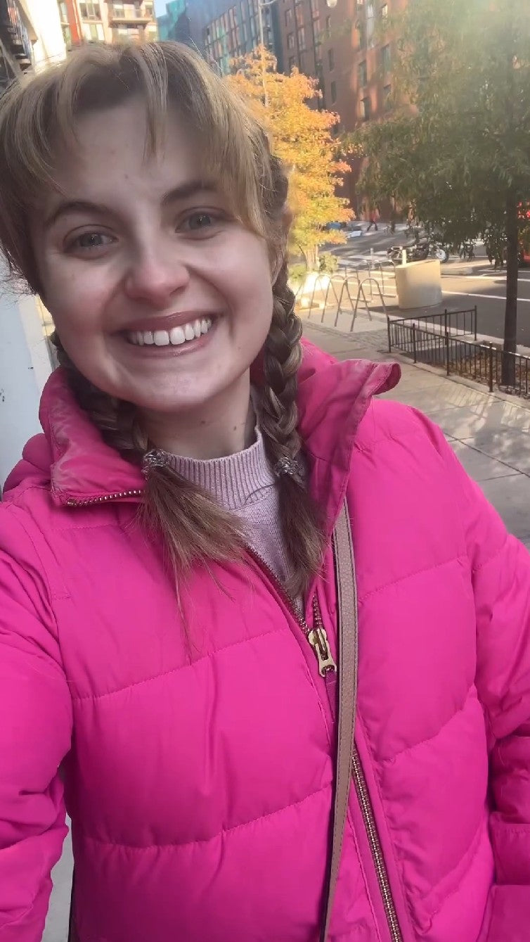 Smiling woman in pink jacket