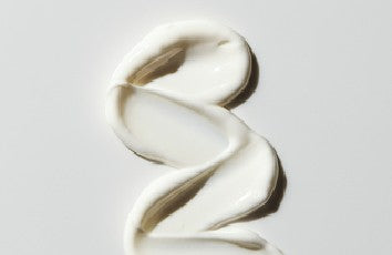 White cream swirl on a light gray background